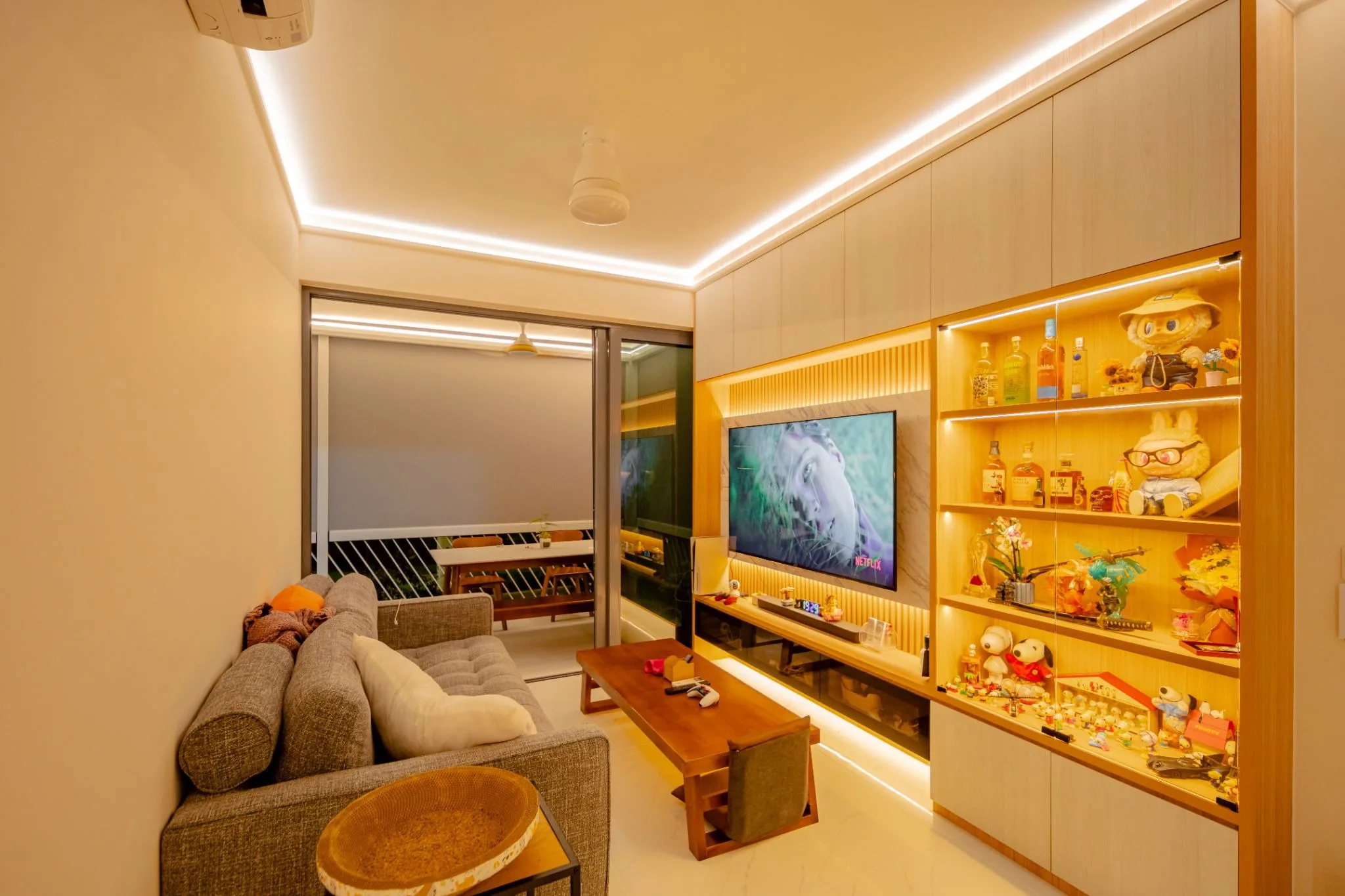 A contemporary TV feature wall elevated by HAGA’s seamless coveless lighting, paired with integrated shelving accents to create a sophisticated, layered glow.