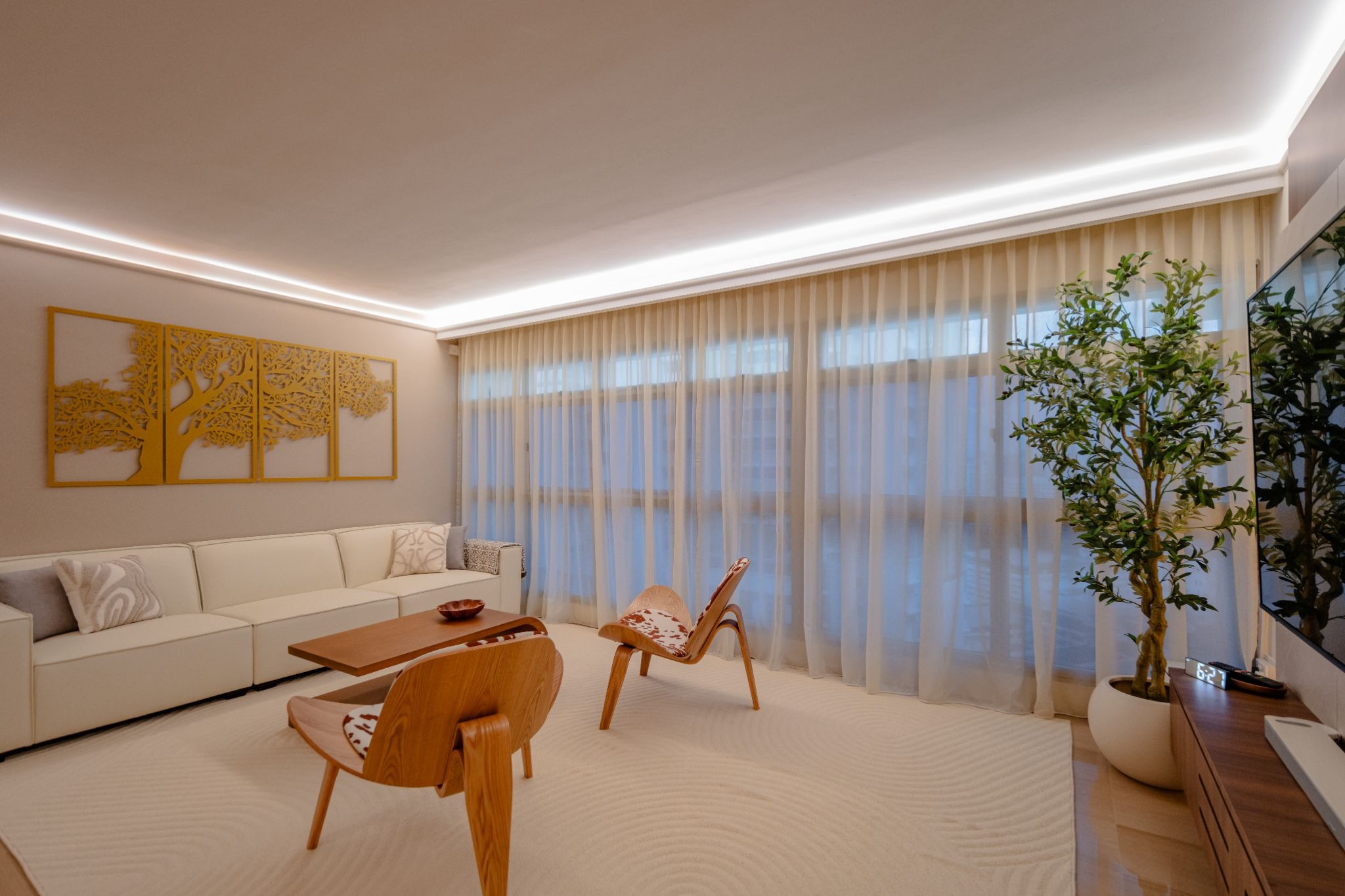 Indirect ceiling lighting using the HAGA system to enhance the height and spaciousness of a minimalist living room.